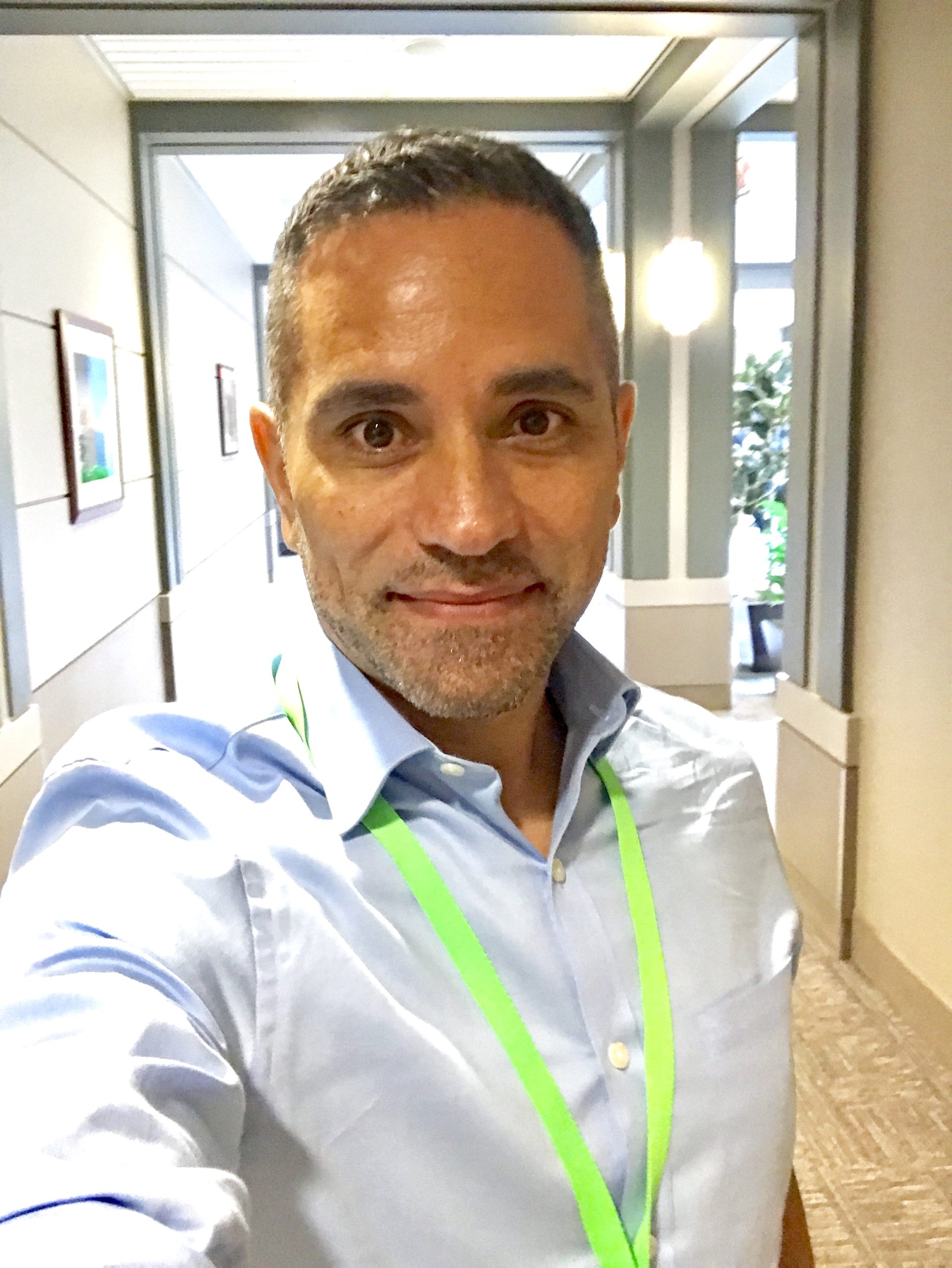 Ezequiel working as an insurance adjuster inspecting a roof